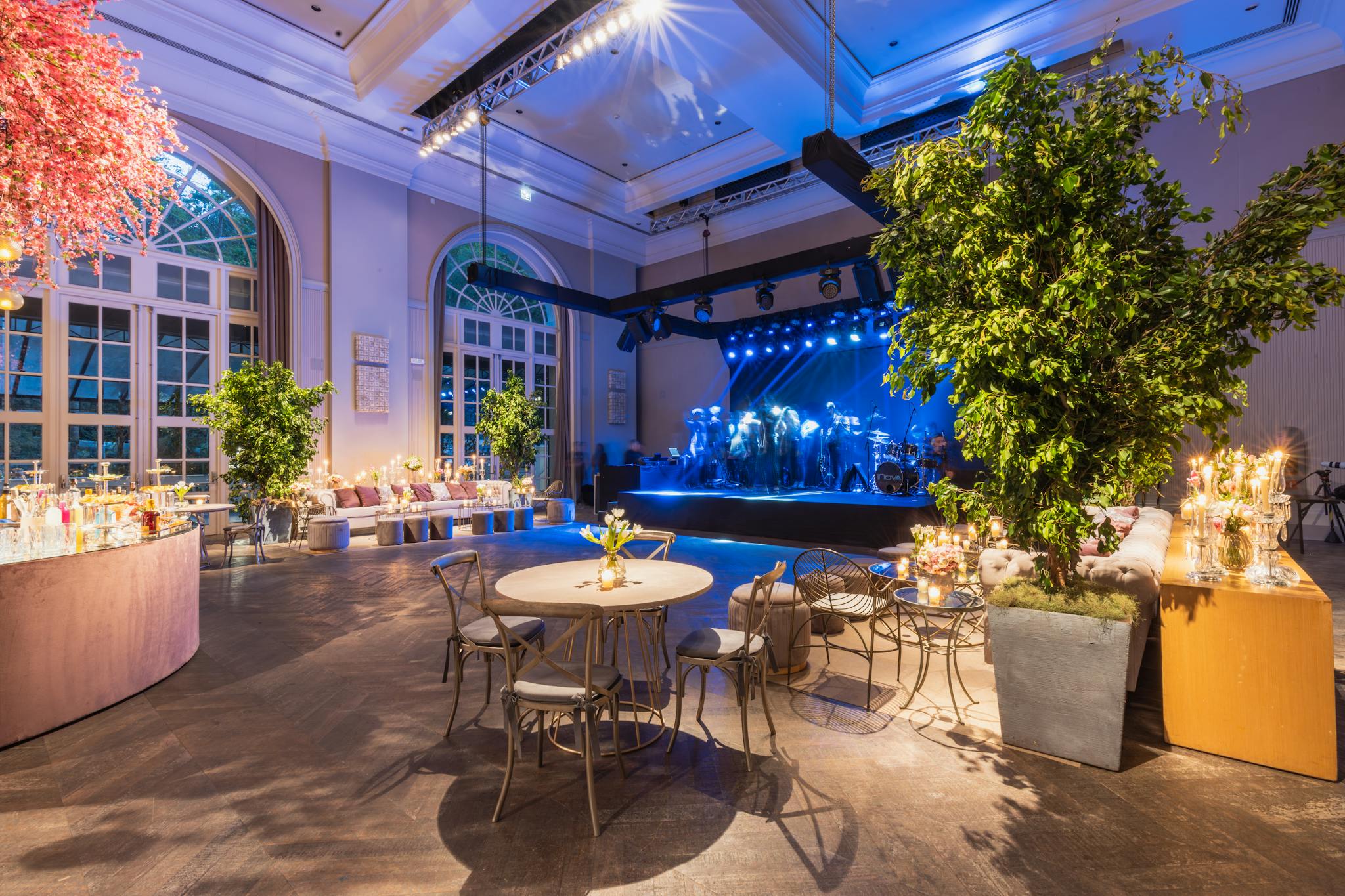 Beautifully decorated indoor venue with a stage, perfect for weddings or events.