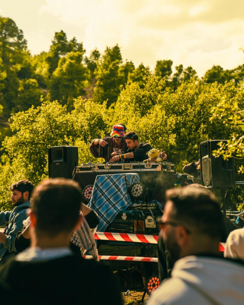 Vibrant outdoor music festival featuring DJs and lively crowd enjoying summer vibes.